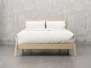 Bellevue bed frame front view in natural brown maple finish.