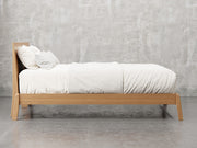 Bellevue bed frame side view in sealy stain.