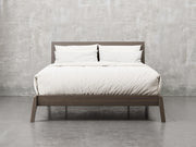 Bellevue bed frame front view in shadow stain.