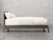 Bellevue bed frame side view in shadow stain.