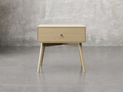 Bellevue nighstand front view in natural brown maple finish.