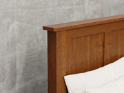 Lansing bed close up view in Michael's cherry stain.