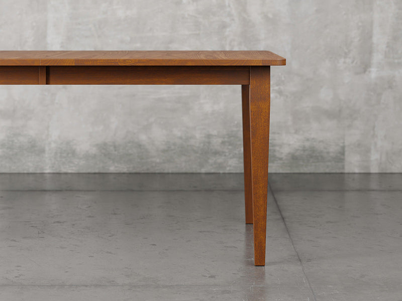Raleigh shaker leg dining table close up view in Michael's cherry stain.