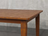 Raleigh shaker leg dining table angle view in Michael's cherry stain.