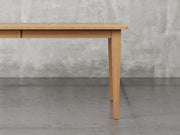 Raleigh shaker leg dining table close up view in sealy stain.