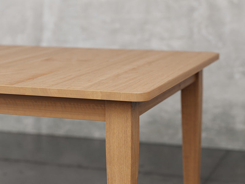 Raleigh shaker leg dining table angle view in sealy stain.